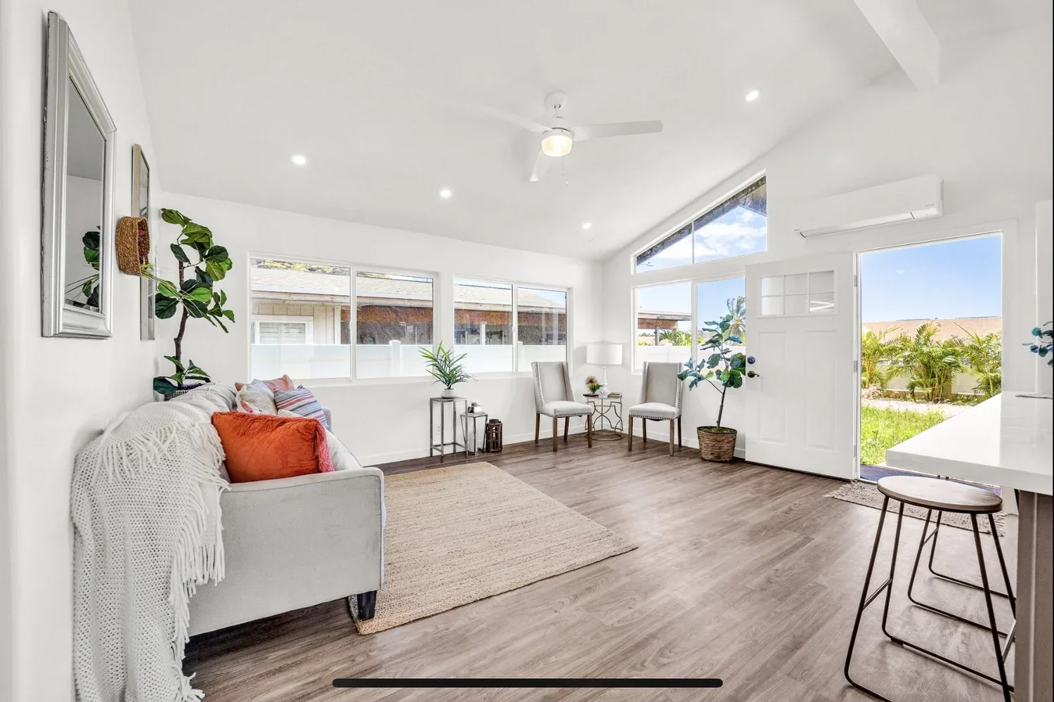 Bright living room with wide windows and seating